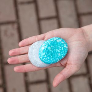 A hand holding shampoo bars